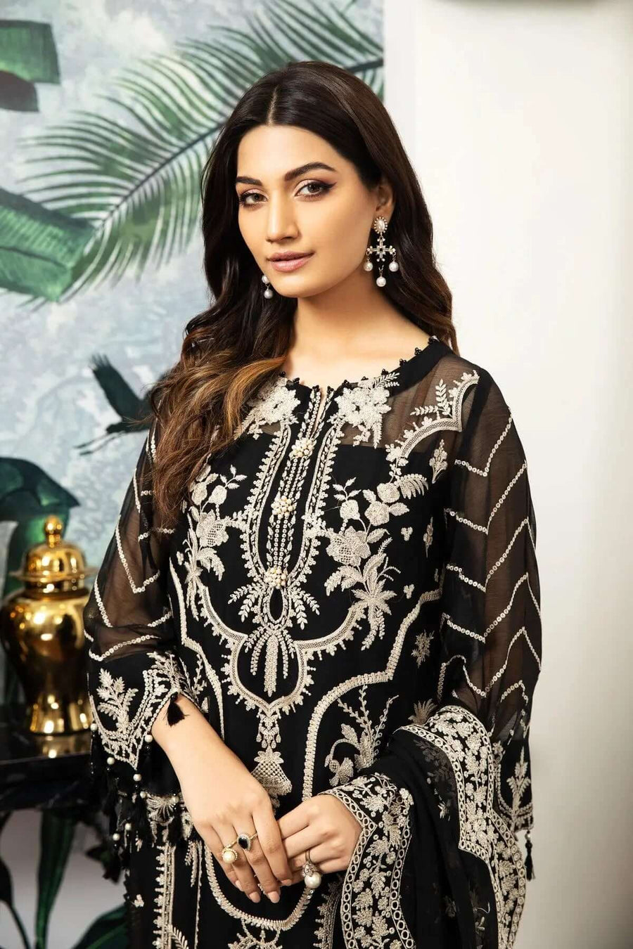 Close-up of blouse neckline and pearl-embellished embroidery on sheer sleeves