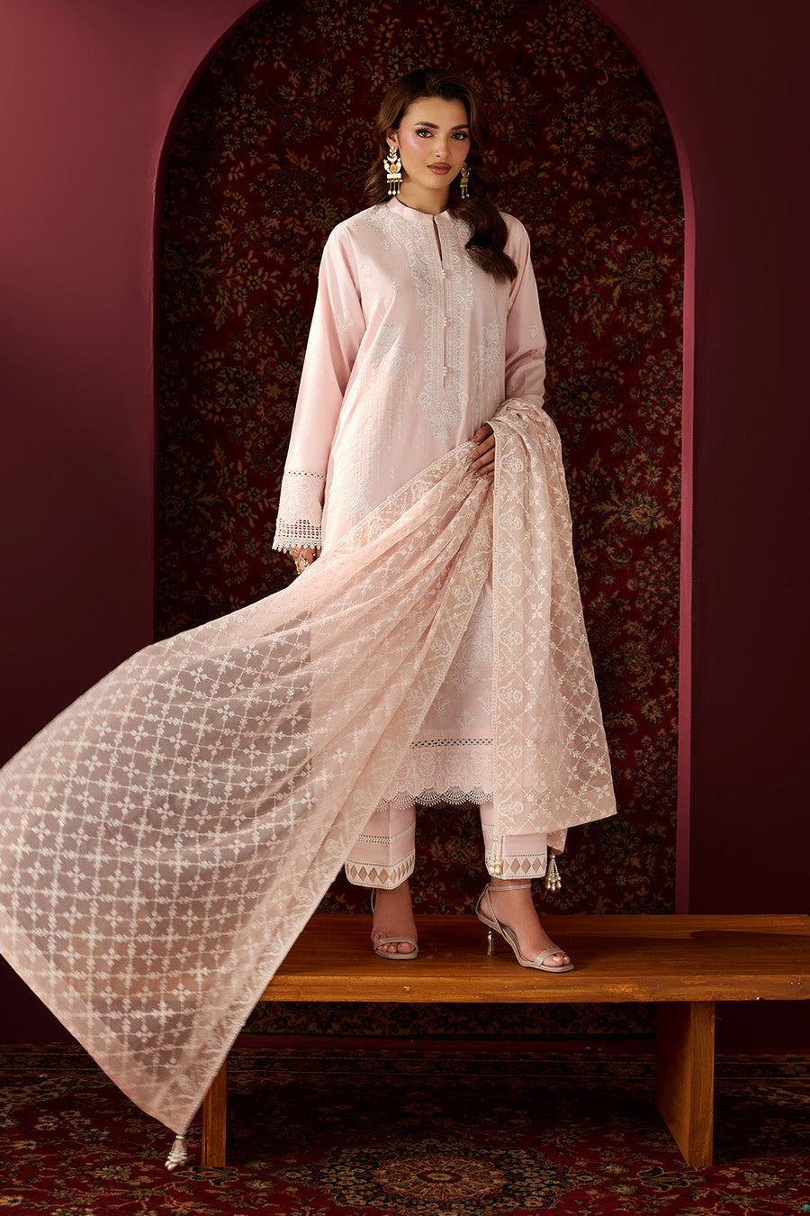 Seated pose highlighting the embroidered lawn shirt and dupatta texture