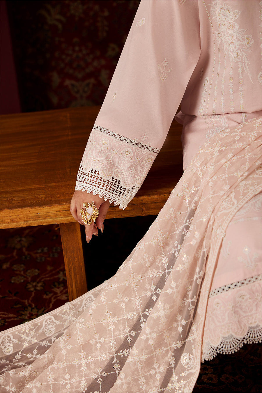Detailed close-up of embroidered chiffon dupatta with floral lattice and pearl tassels