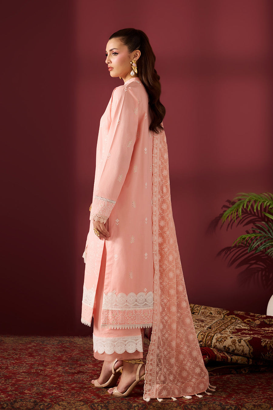 Side view showing detailed embroidery on back and sleeves of lawn shirt with dupatta draped