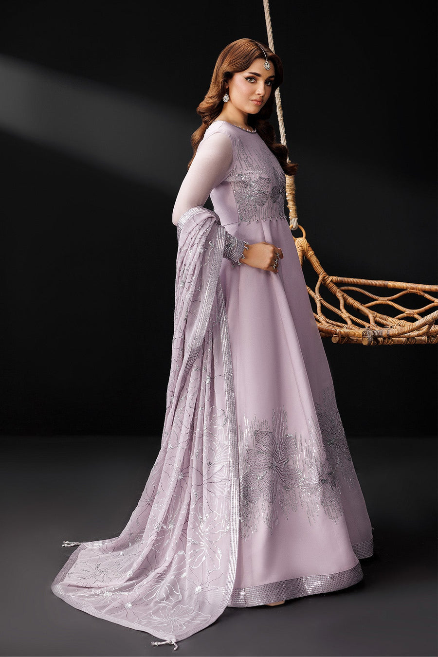 Model holding embroidered dupatta showcasing floral silver pattern