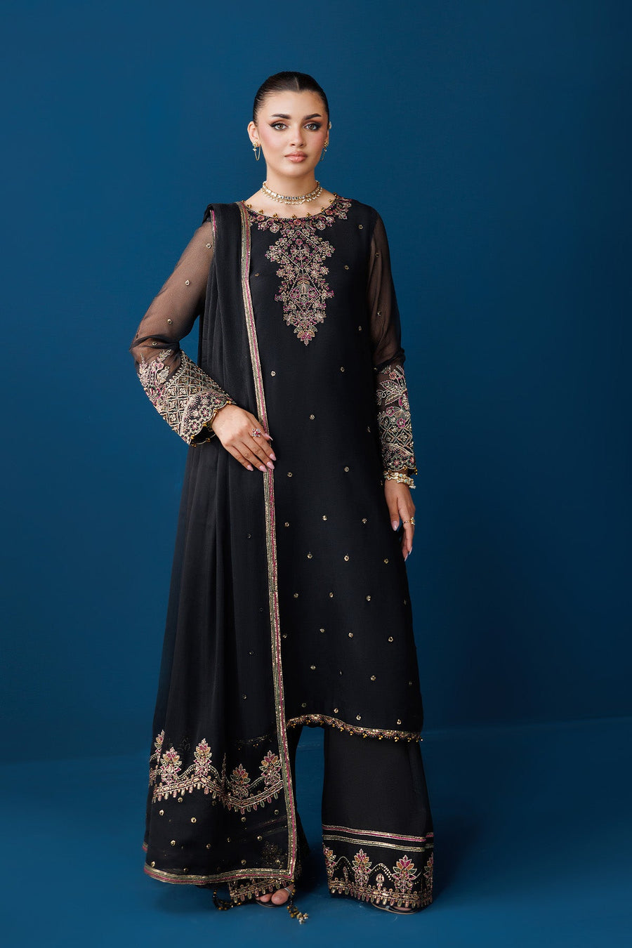 Woman wearing a black chiffon embroidered kameez suit with detailed motifs and matching dupatta
