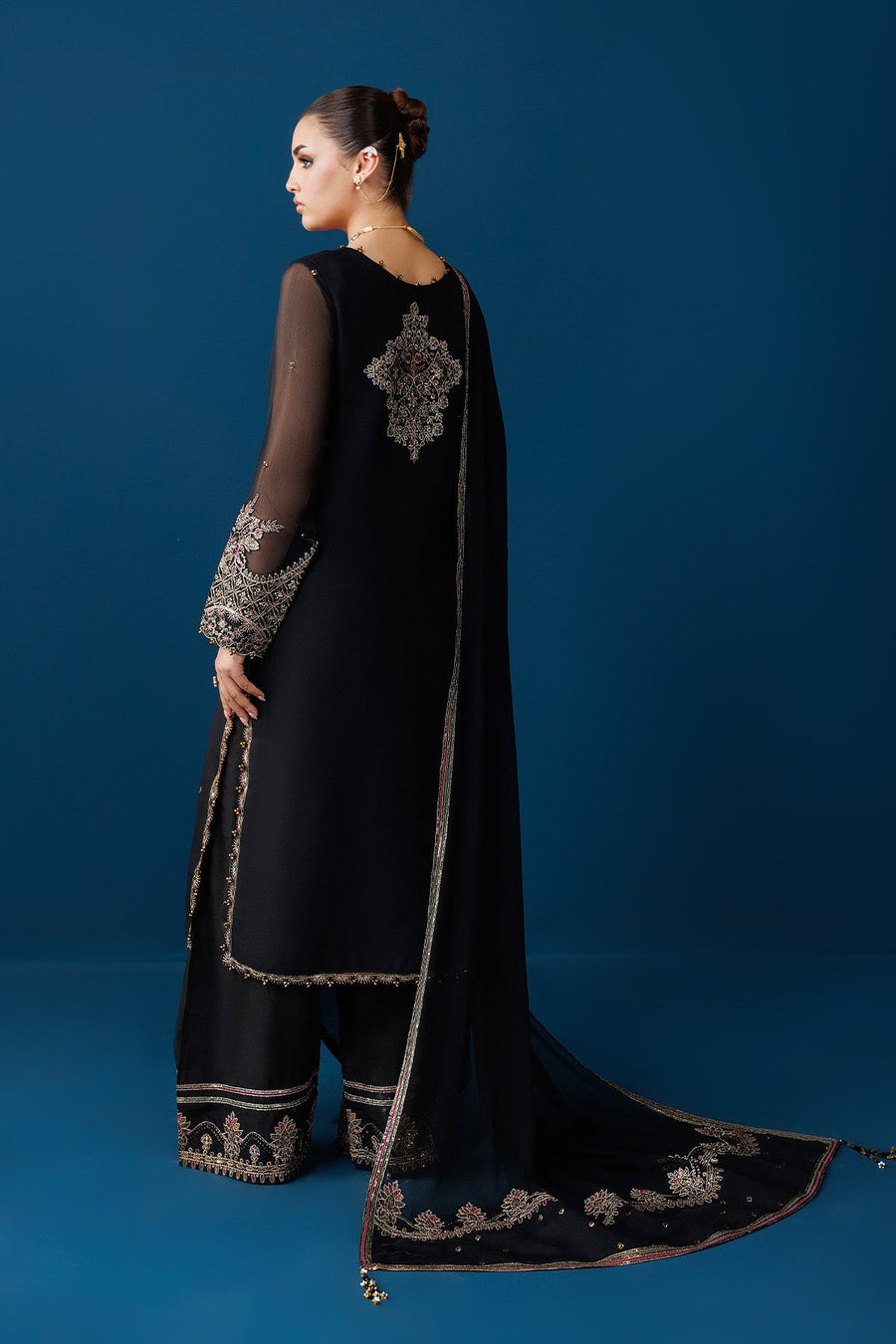 Back view of black chiffon suit showing embroidered design on the back and embroidered trouser hems