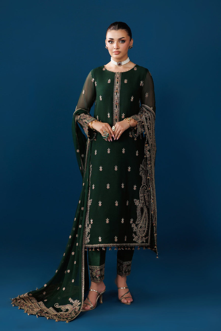 Full front view of model wearing embroidered emerald green suit and dupatta