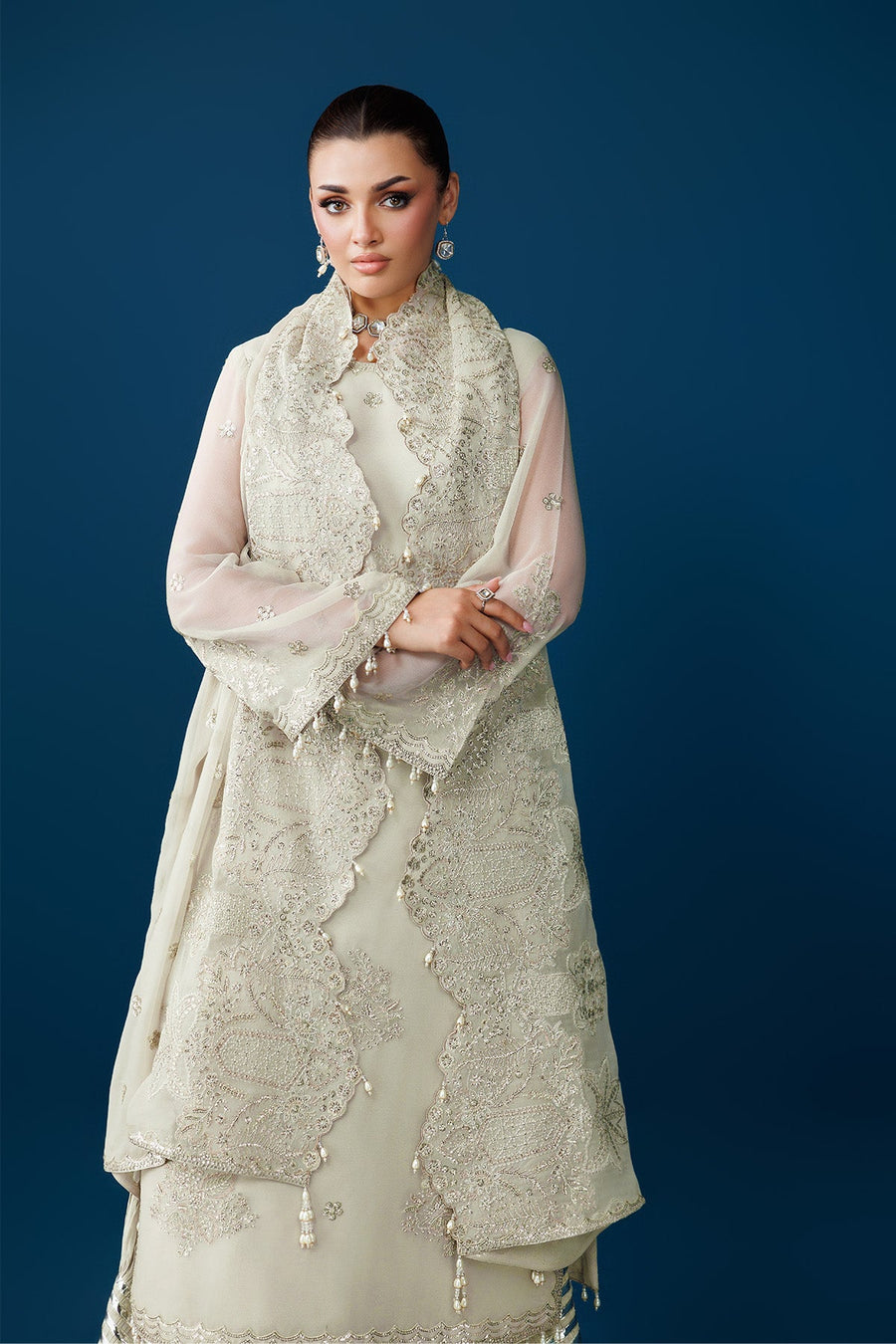 Detailed shot of embroidered borders and bead tassels on chiffon dupatta and sleeves