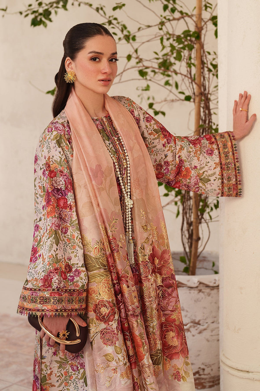 Full front view of model seated, showing full floral embroidery on kameez and embroidered dupatta draped elegantly