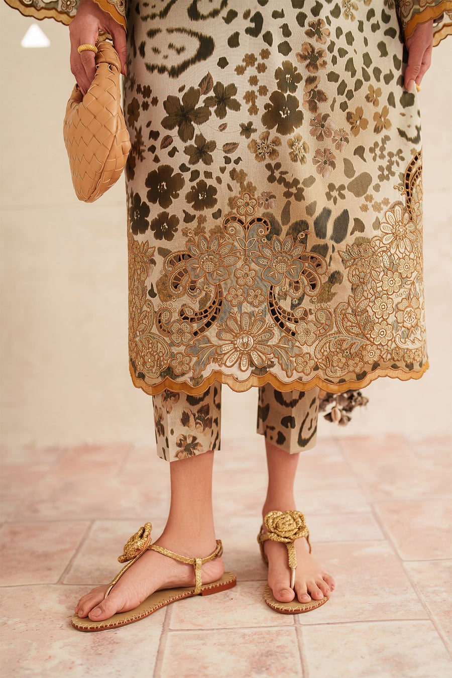 Full frontal view of model wearing embroidered lawn suit with dupatta draped around her neck