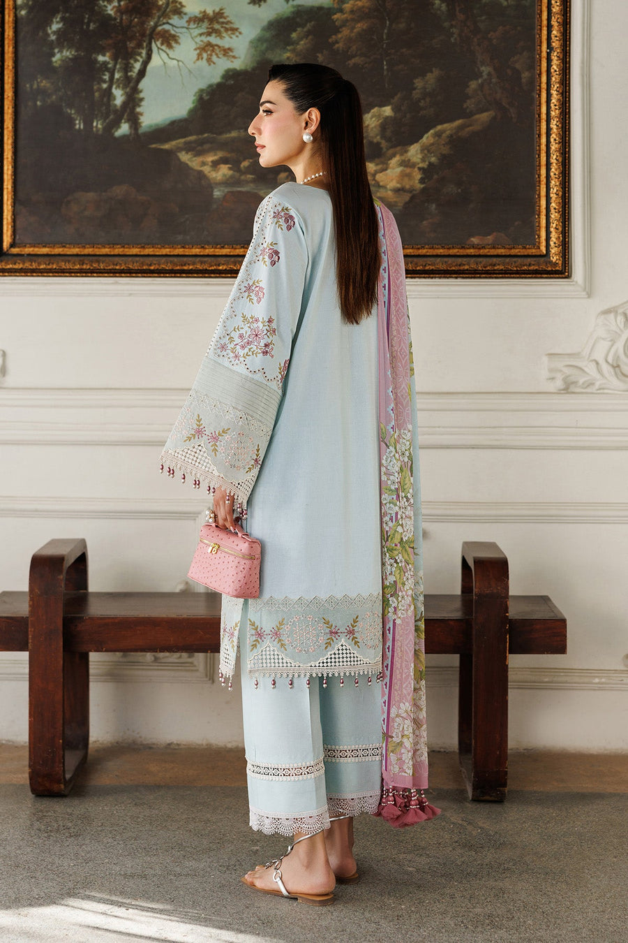 Close-up of wide-leg trouser hem with intricate lace trimming