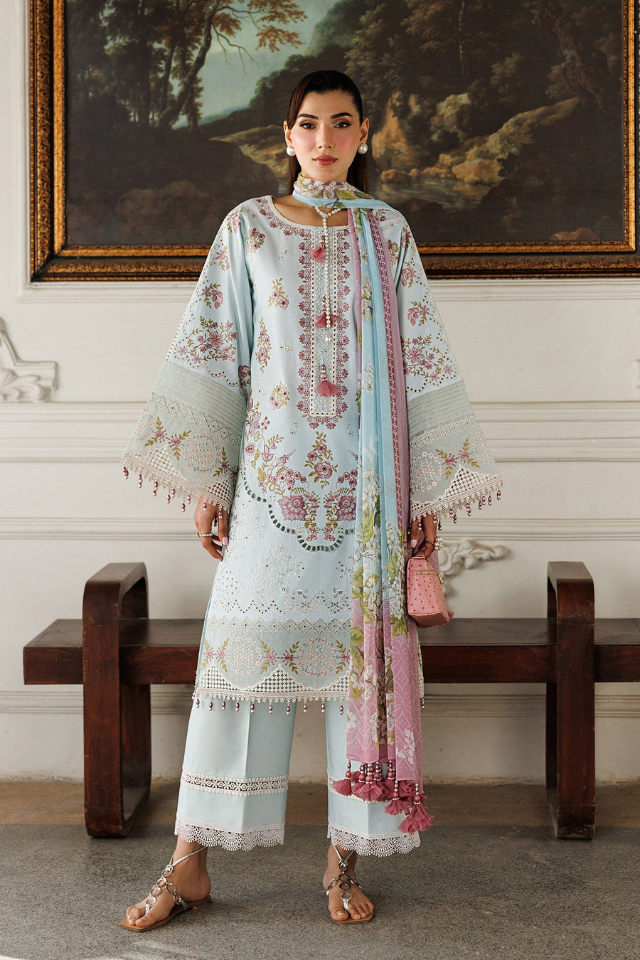 Front view of woman wearing light blue embroidered lawn suit with floral design and pink blue dupatta