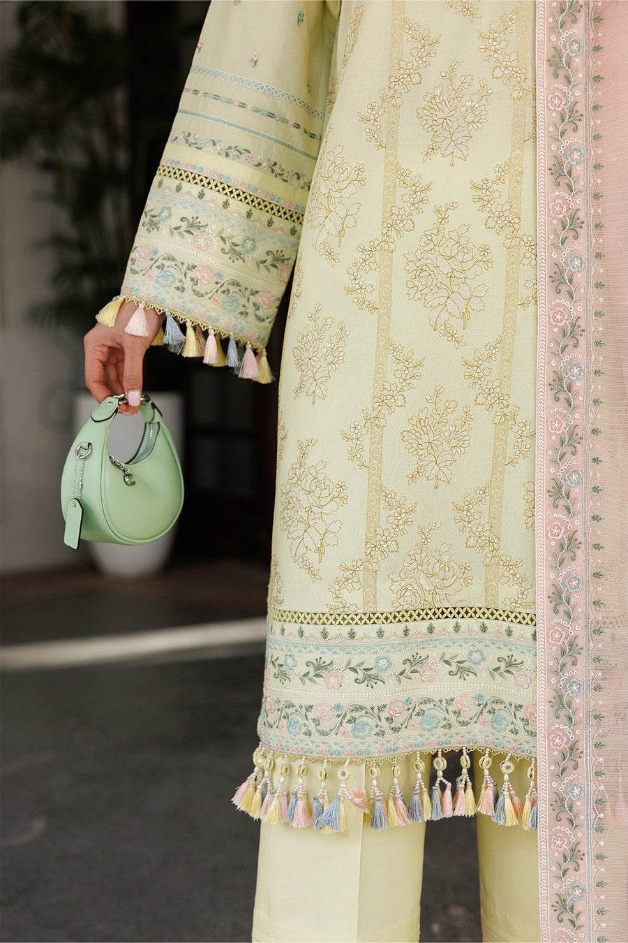 Detailed embroidery on pink dupatta border with floral motifs and tassels