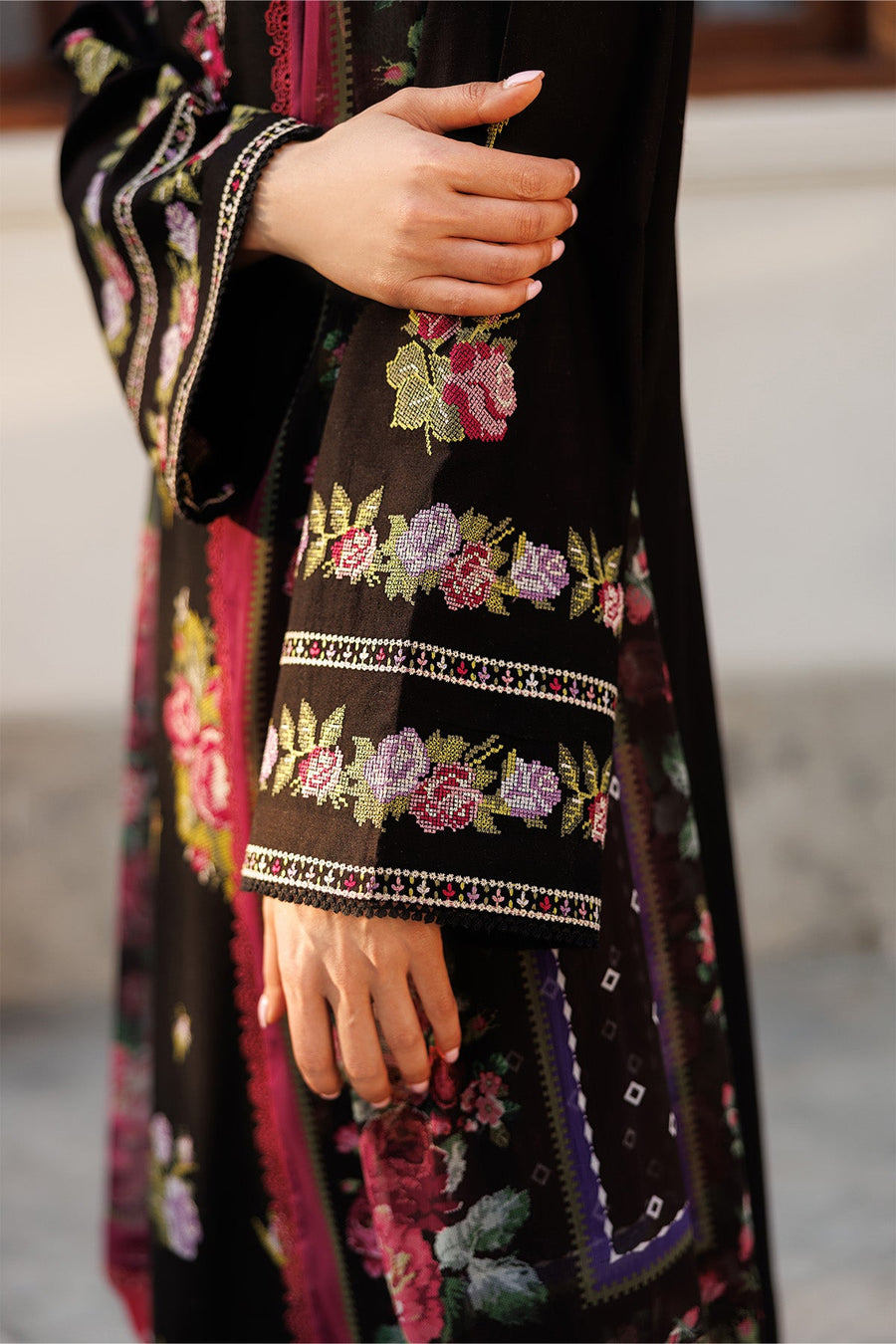 Close-up side view of sleeve embroidery showing intricate floral lace border