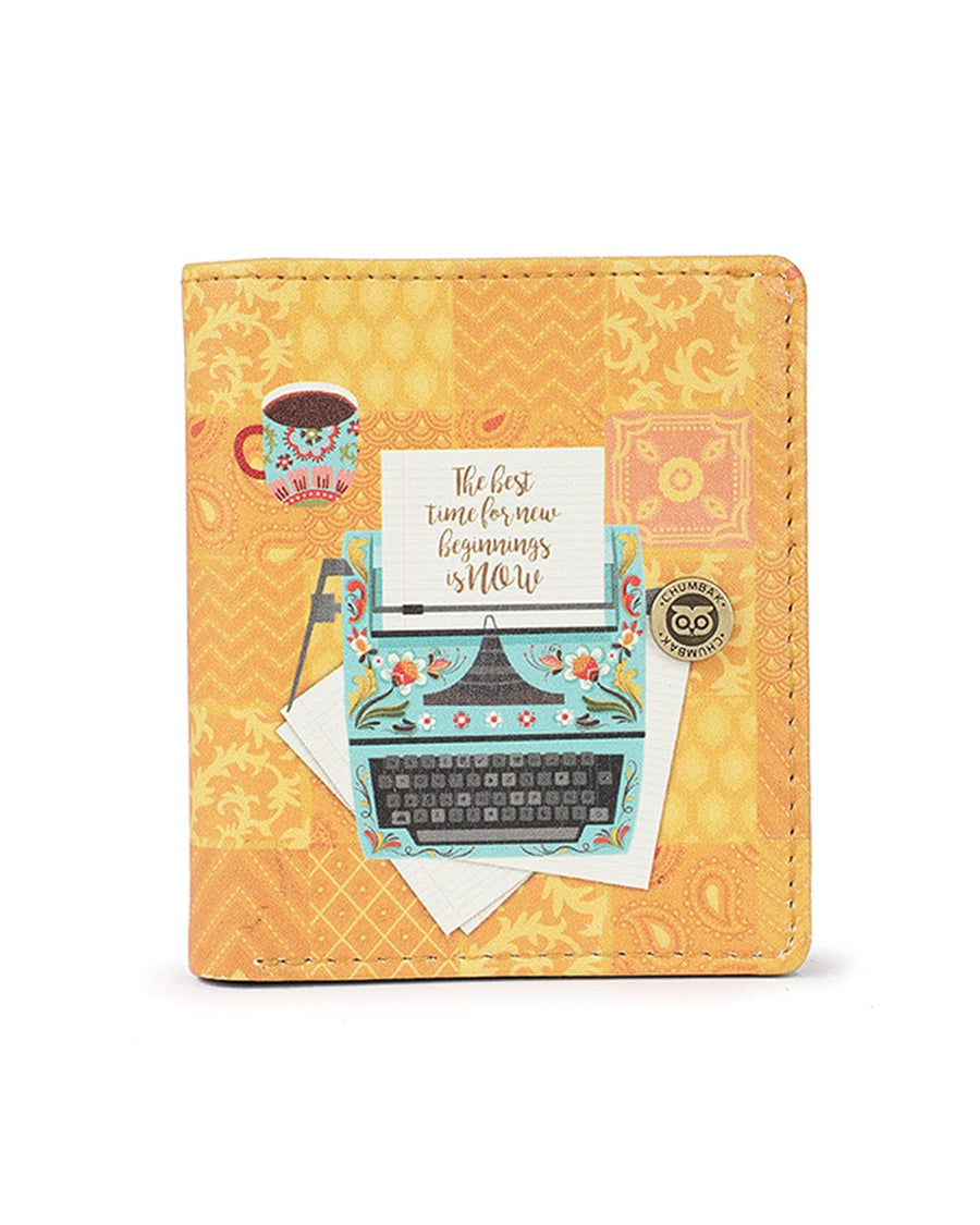 Yellow-orange wallet featuring a vintage turquoise typewriter with floral design, a coffee cup, and motivational quote with snap button closure