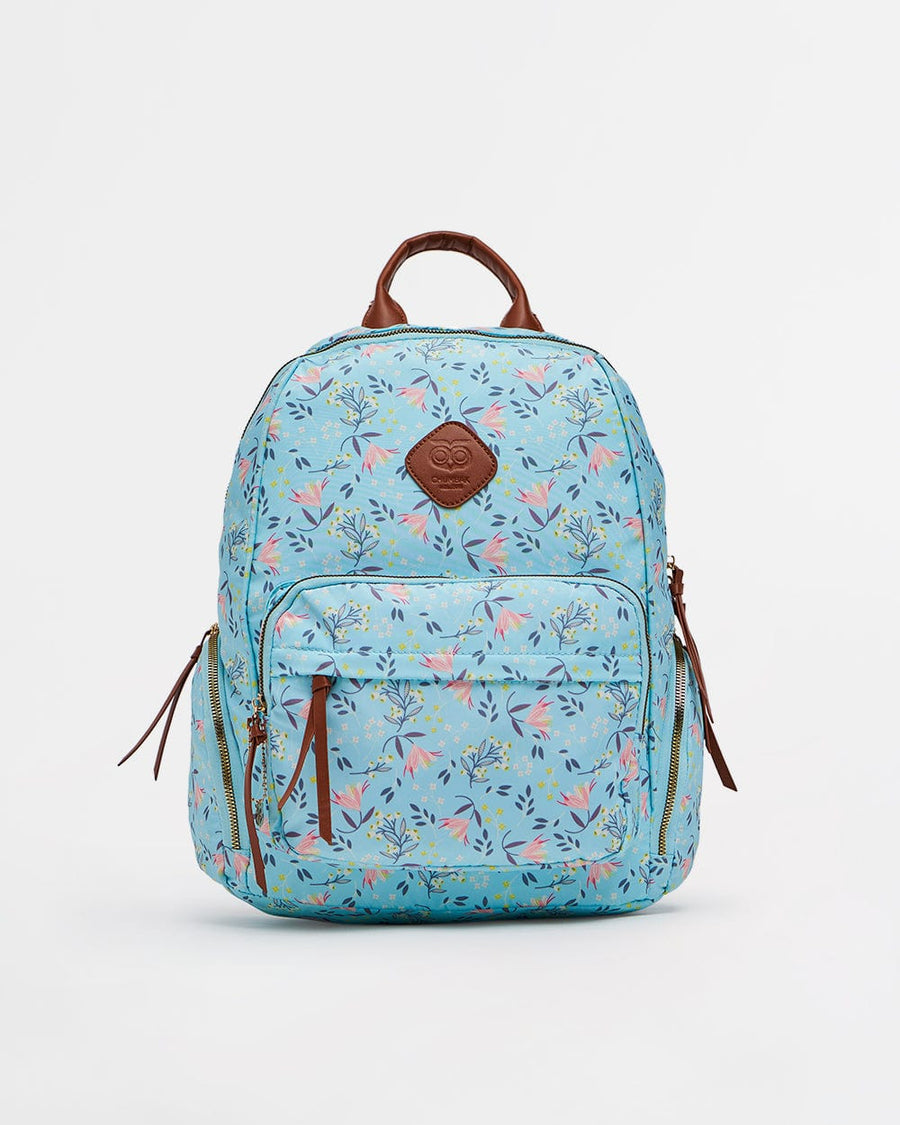 Light blue women's backpack with pink floral print, brown leather-like handle and zipper pulls, featuring multiple zippered compartments.