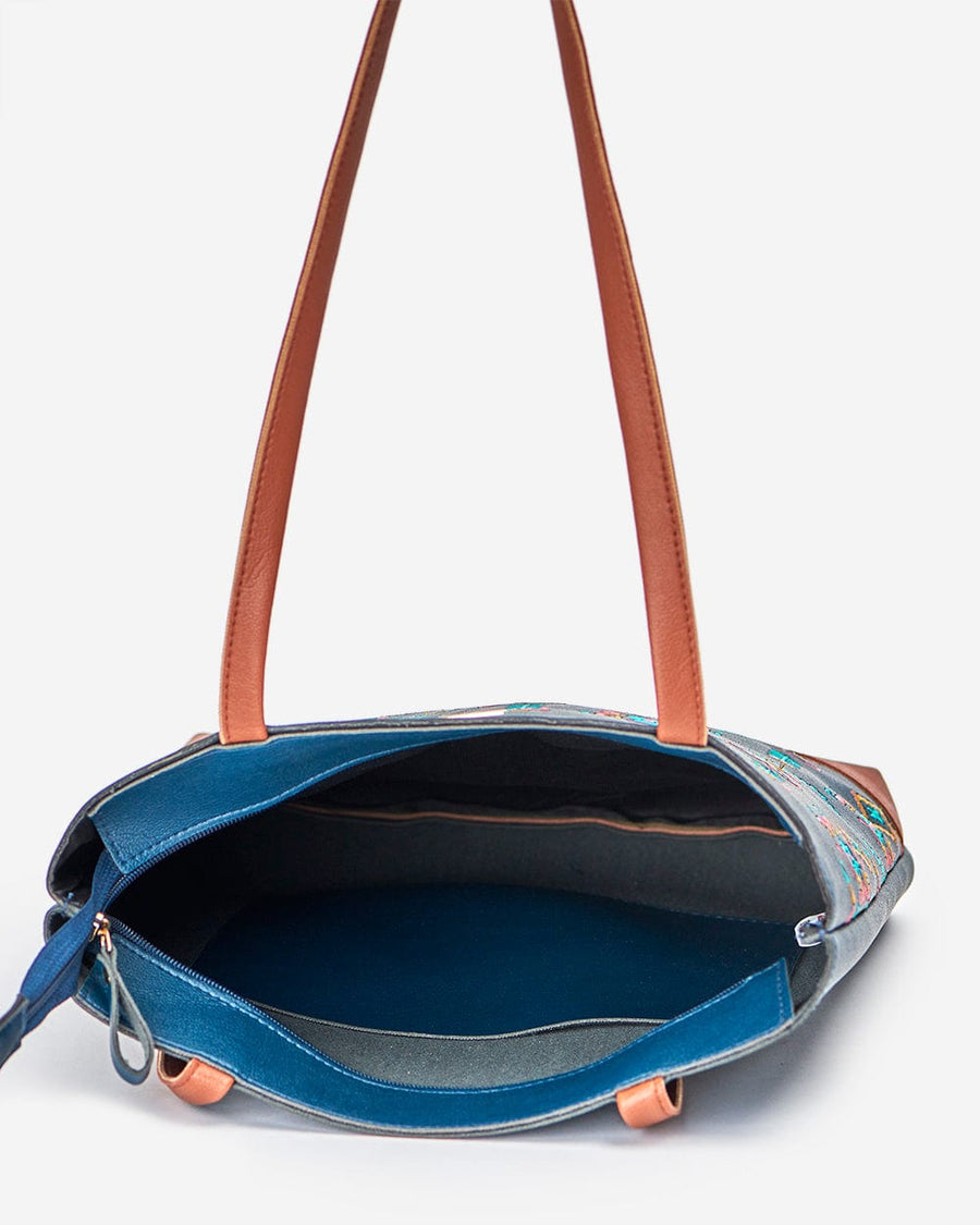 Top open view of navy embroidered tote bag displaying spacious main compartment and inner pocket