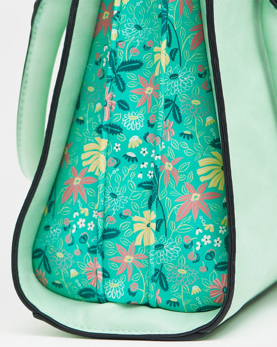 Close-up of floral patterned side panel on mint floral structured handbag highlighting colorful floral print