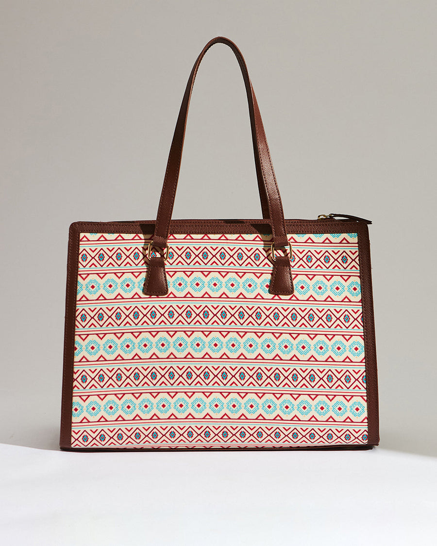 Open top view inside the tote featuring a spacious brown interior with multiple compartments including a padded laptop sleeve