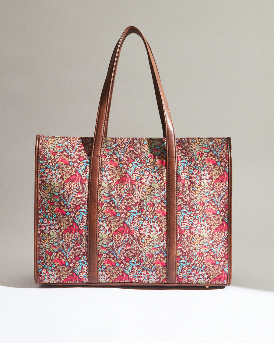 Close-up view inside the tote bag showing maroon fabric lining, zipper pocket, and organizational slots with magnetic closure