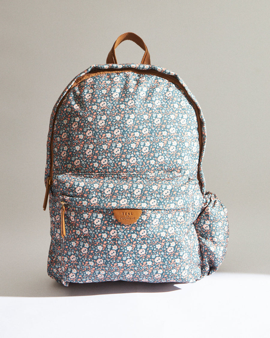 Floral printed teal backpack with front zip pocket and side elastic bottle holder