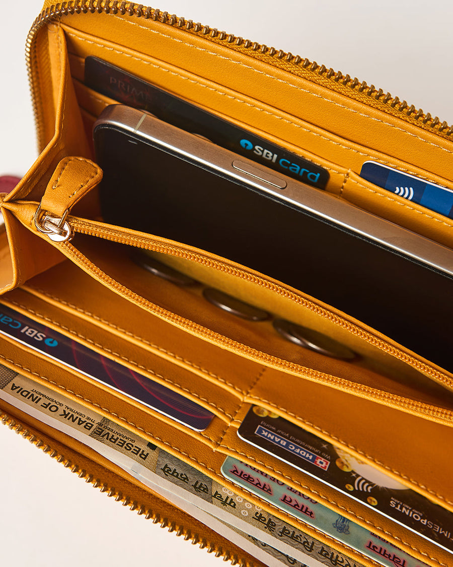Interior view of open wallet showing multiple card slots, cash compartments, and smartphone inside