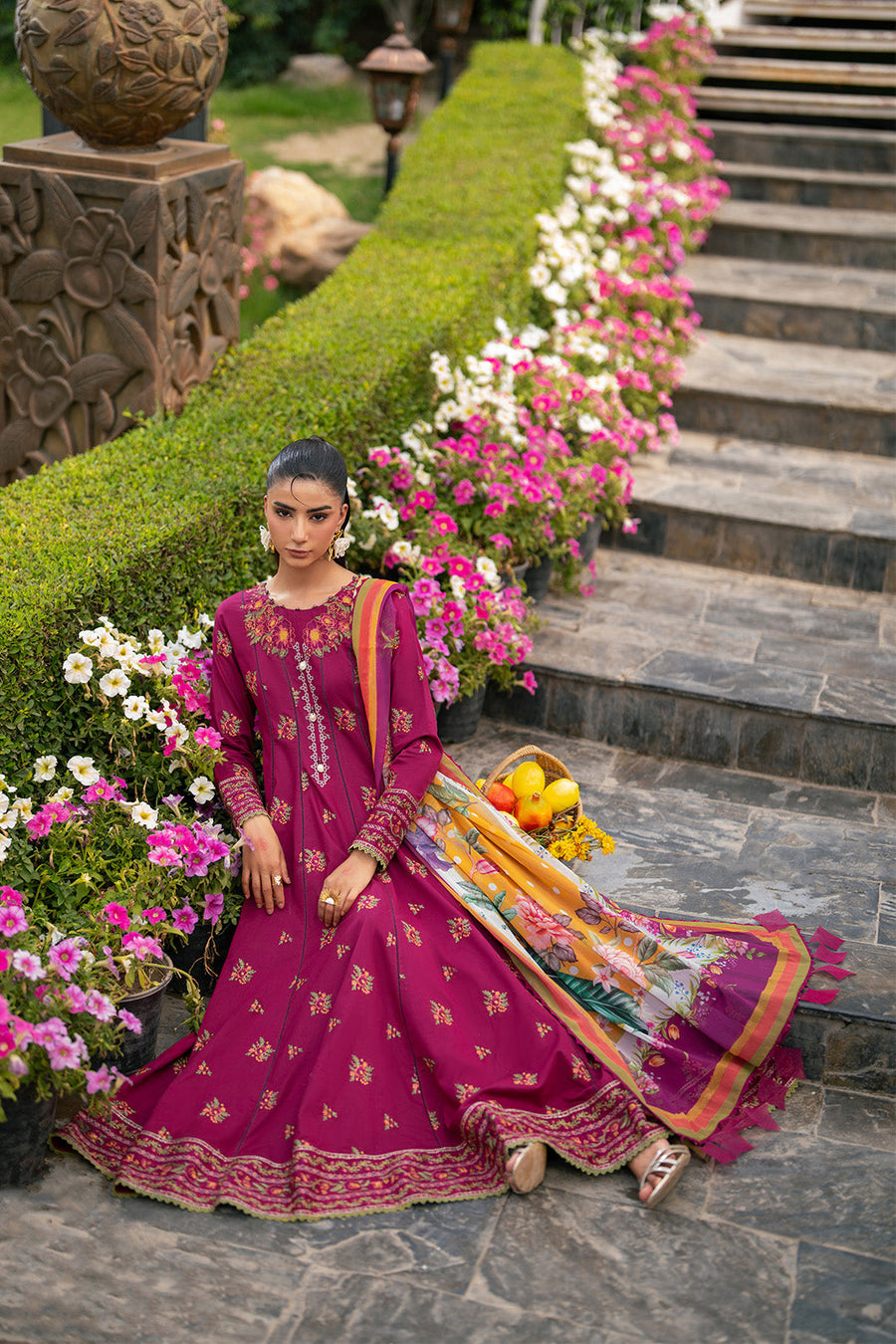 Close-up front view of woman in embroidered floral maxi dress with printed chiffon dupatta