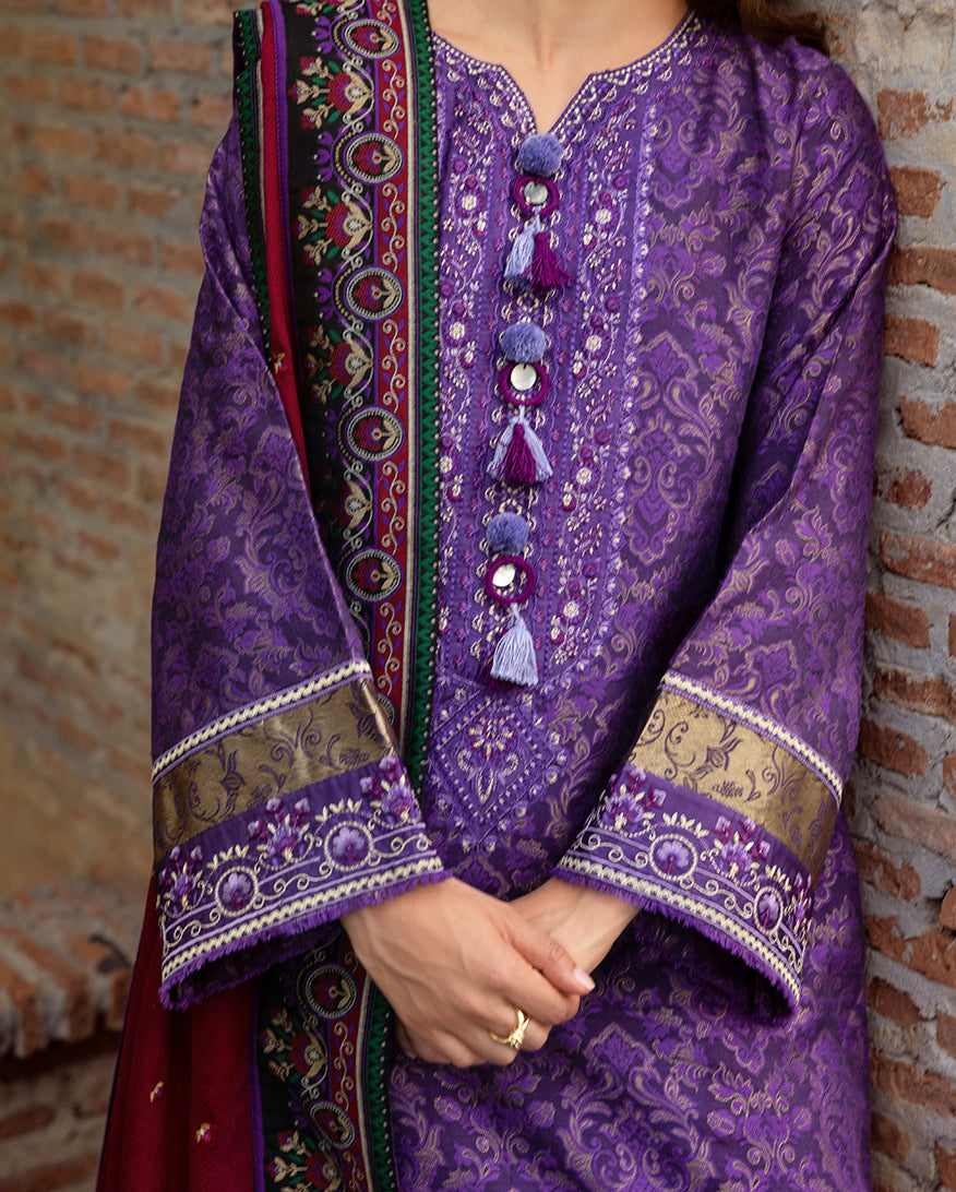 Detailed view of the purple jacquard shirt focusing on the embroidered cuffs and neckline featuring silk tassels and mirrored embellishments with embroidered shawl edge visible.