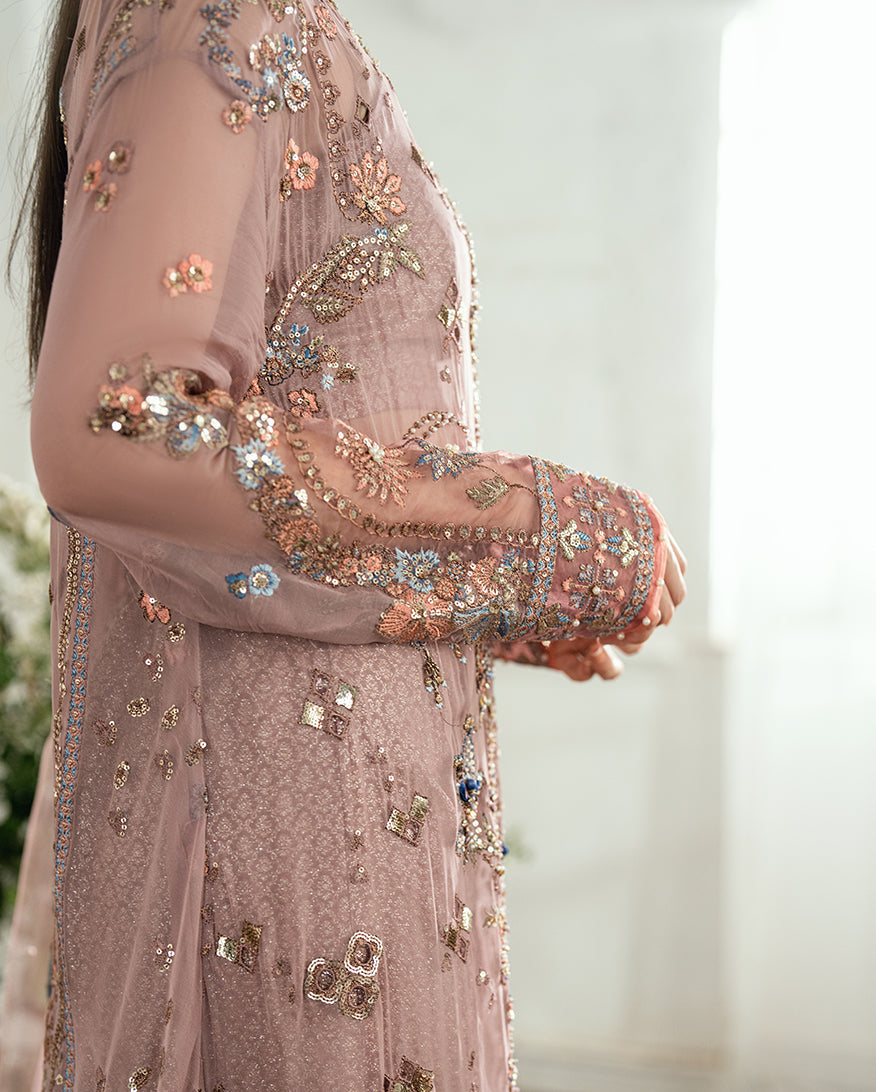 Detailed close-up of the fully embroidered sleeves and cuffs with pearl and sequin embellishments