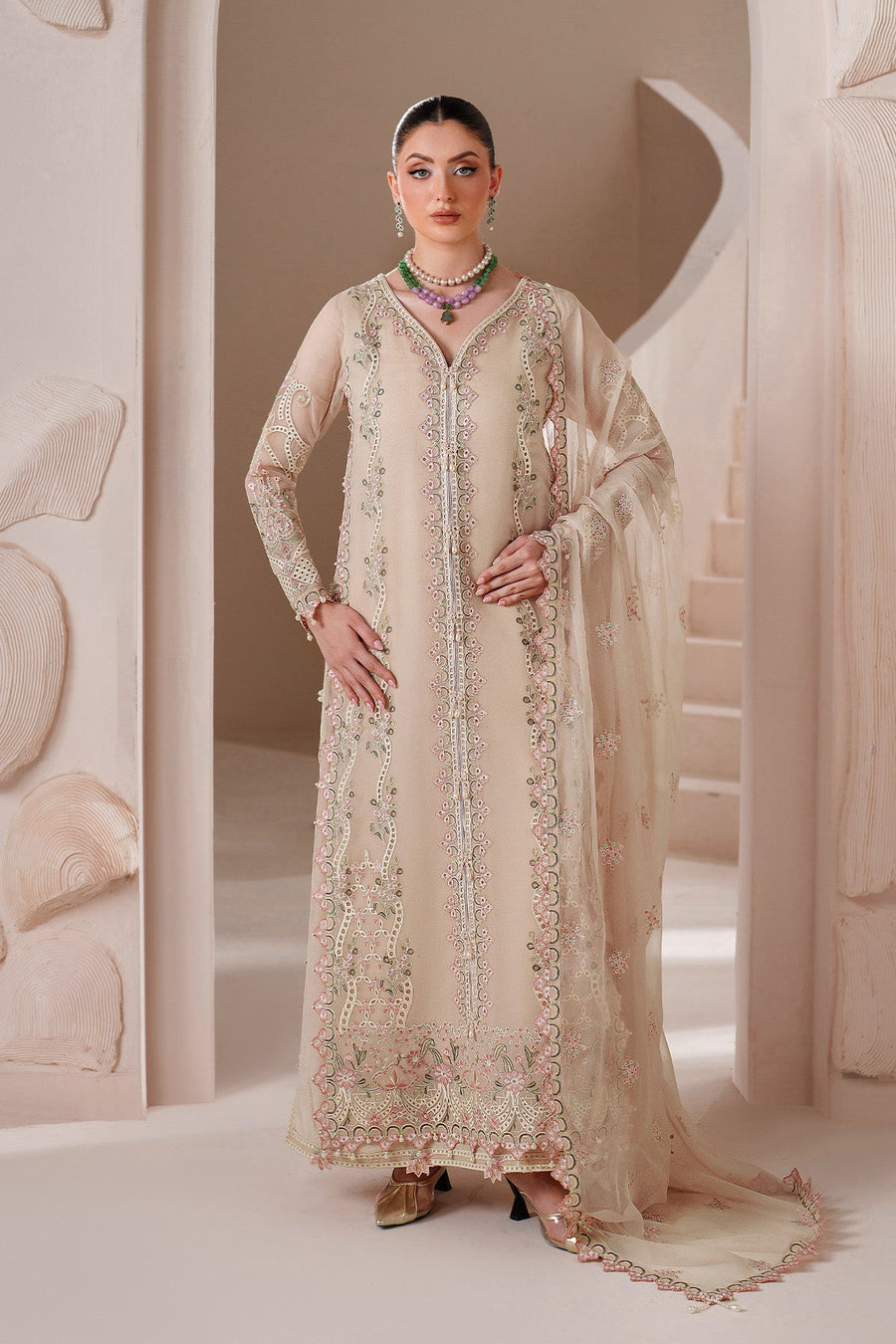 Woman poses holding chiffon dupatta embroidered with floral motifs matching dress