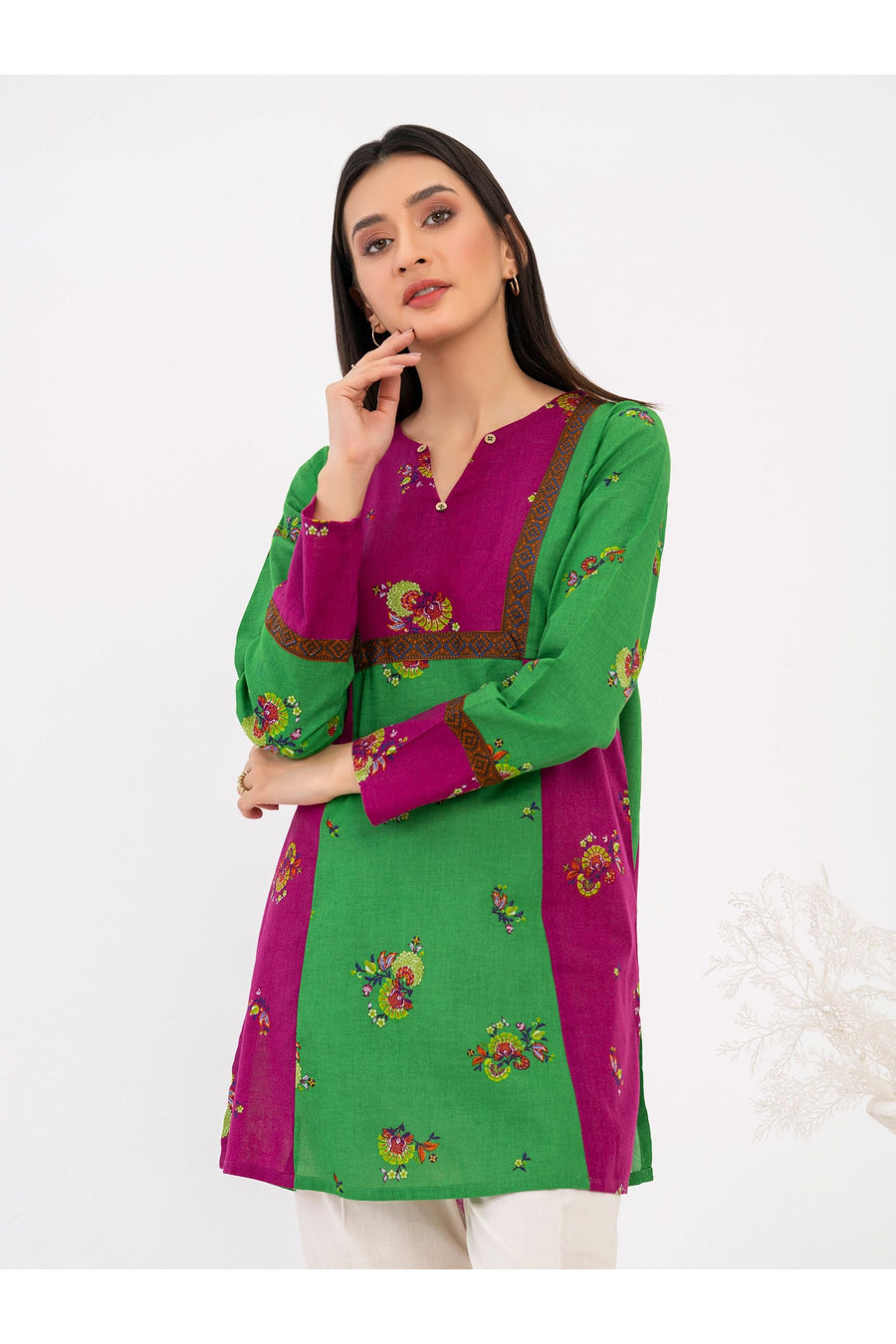 Front view of woman wearing green and magenta khaddar printed kurti
