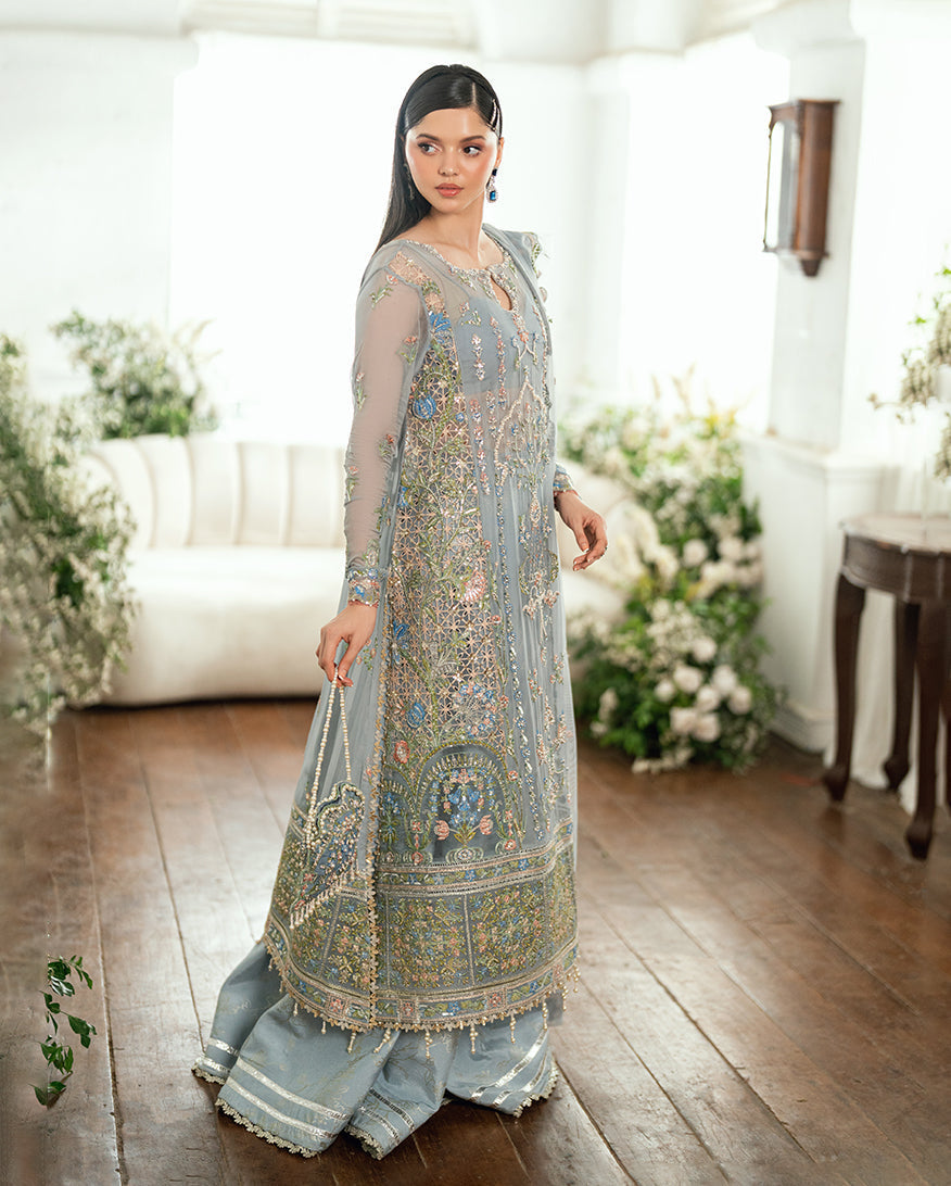 Side view of pastel blue chiffon dress featuring detailed floral embroidery and sheer long sleeves with sequin accents