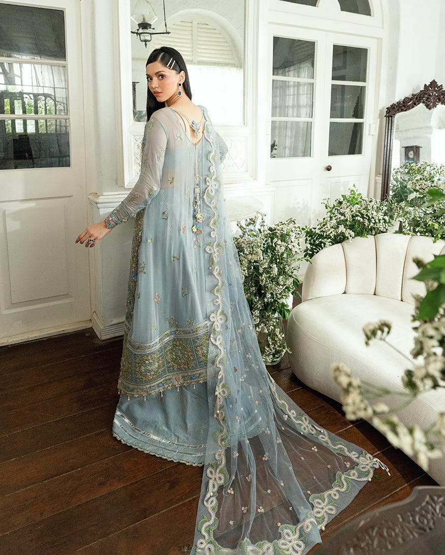 Back view of blue chiffon dress showing embroidered back design with pearl embellishments and flowing dupatta with scalloped edges