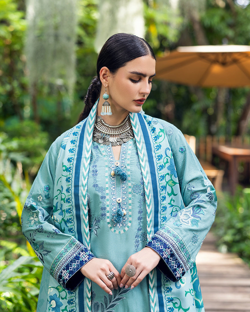 Close-up of the upper part of the outfit, focusing on the intricate embroidery on the sleeves, neckline, and the decorative tassels on the shirt's front placket.