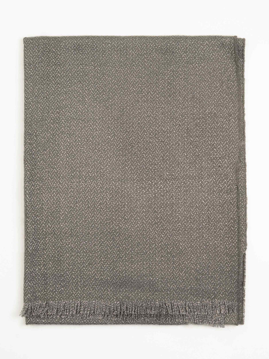 Slate grey wool shawl folded flat showing full width and delicate fringed borders on white background