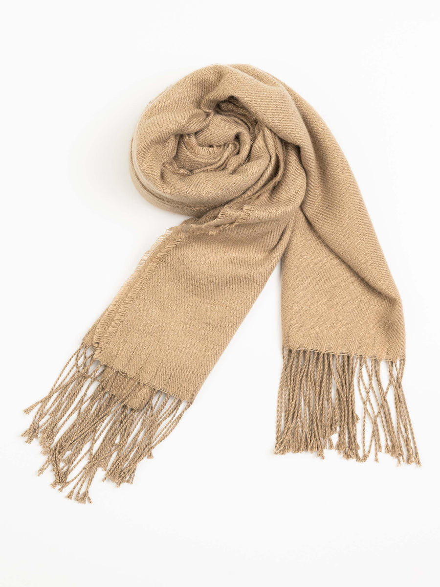 Rolled camel wool shawl emphasizing smooth fabric and twisted fringed tassels
