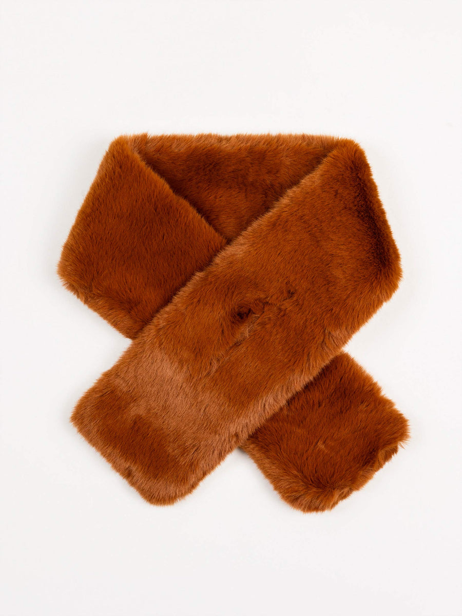 Rust brown plush fur muffler folded on a white background highlighting its dense soft texture