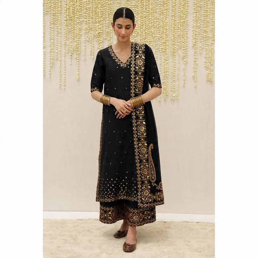 Front view of black embroidered tunic with matching wide trousers and gold embellished dupatta