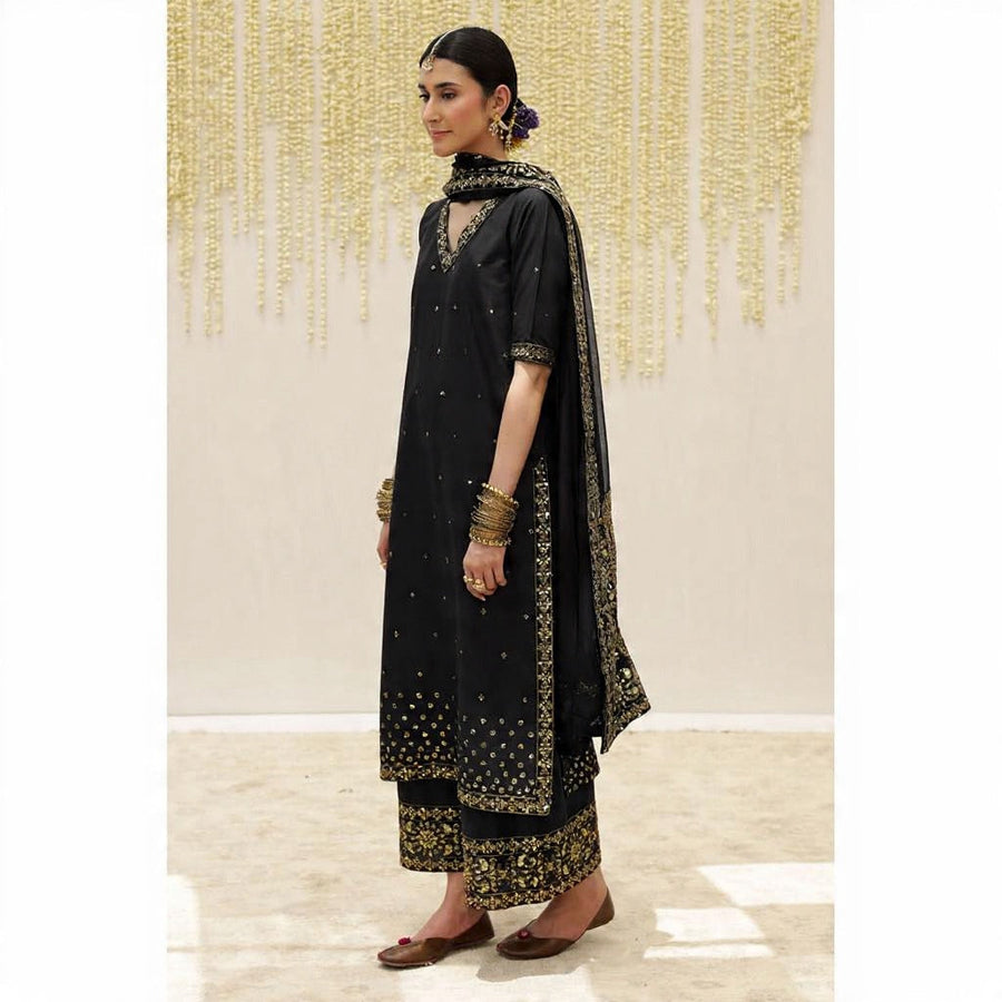Side view of black formal 3-piece suit with gold embroidery and sheer dupatta draped over shoulder