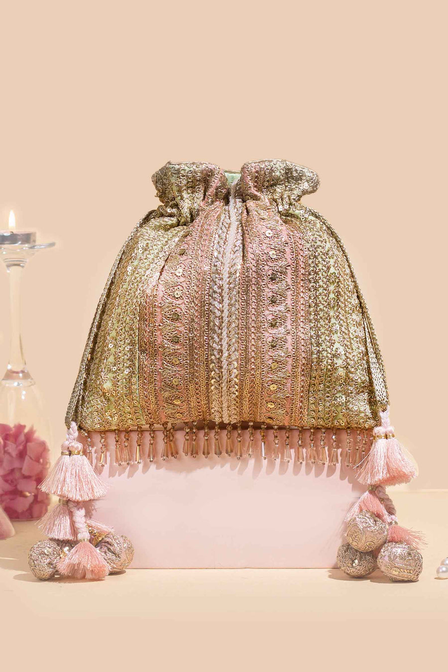 Pastel Naaz embroidered potli bag with tassel embellishments and sequin accents on a neutral background