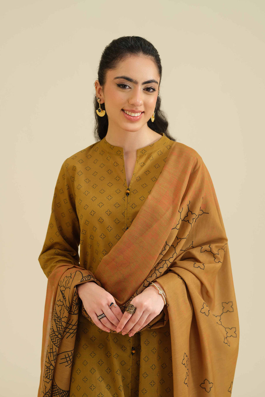 Model posing front view showing buttons and neckline details of kurta