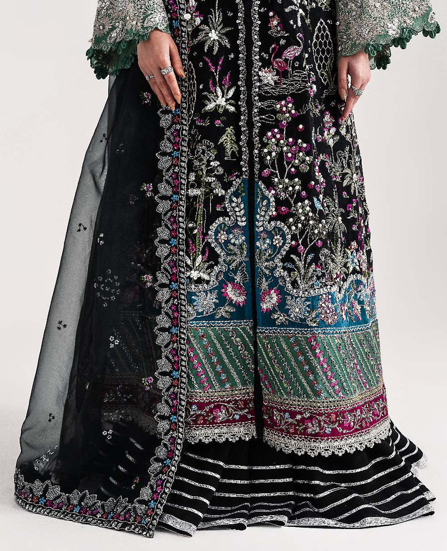 Close-up showing model holding embroidered dupatta with scalloped edges and floral details