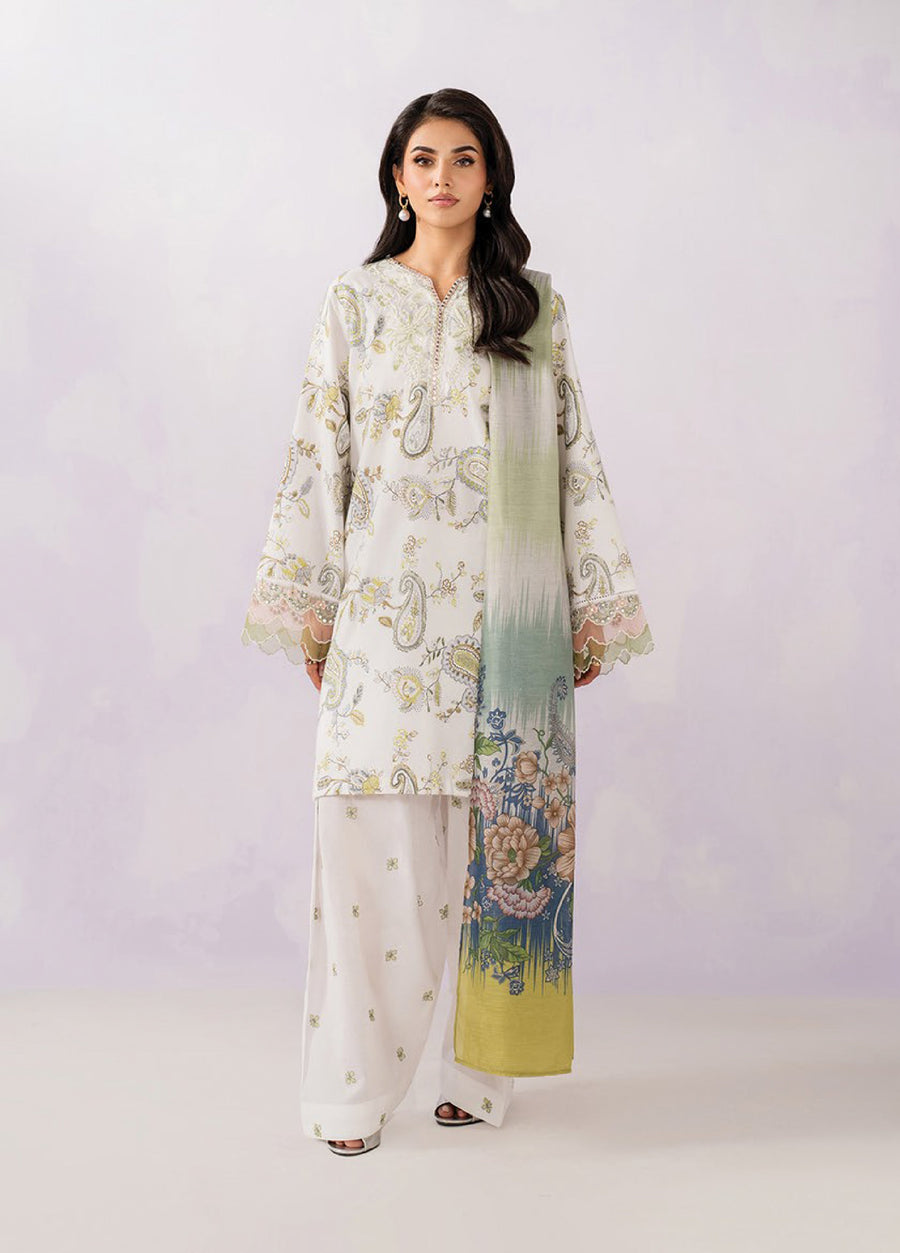 Woman wearing an elegant cream-colored embroidered lawn suit with botanical motifs, paired with loose trousers and a green and floral printed dupatta.