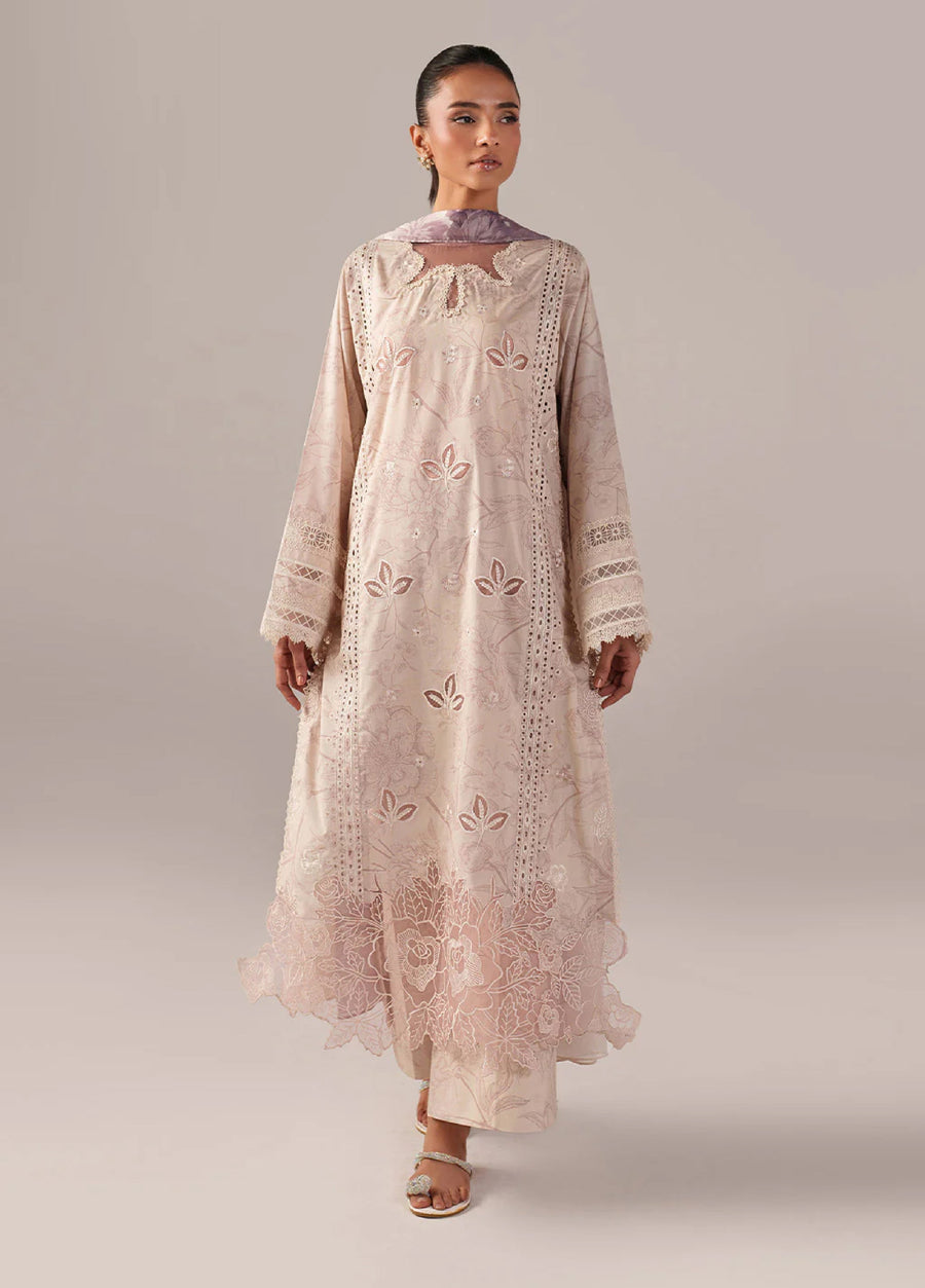 Front view of a woman wearing an elegant beige embroidered lawn suit with floral lace hem and detailed sleeves
