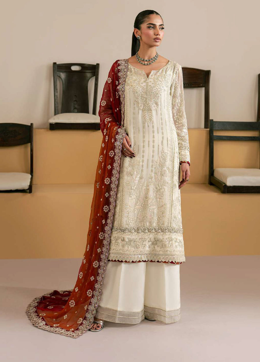 Front view of woman wearing embroidered ivory chiffon long shirt with wide-leg palazzo pants and red-orange gradient dupatta with floral embroidery
