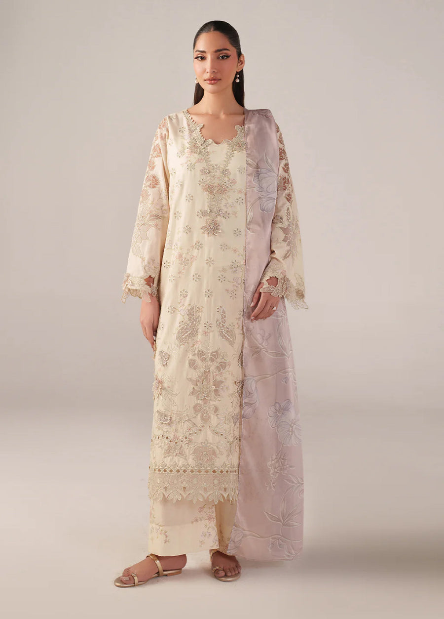 Woman wearing an elegant cream embroidered lawn suit with lace detailing and a pastel pink floral embroidered dupatta draped over shoulder