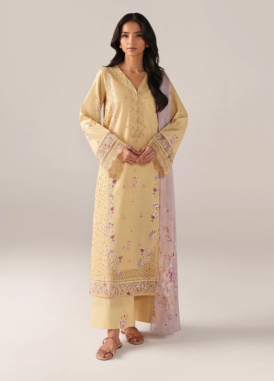 Woman wearing a pastel yellow embroidered lawn suit with floral patterns and a lilac dupatta, standing facing forward.