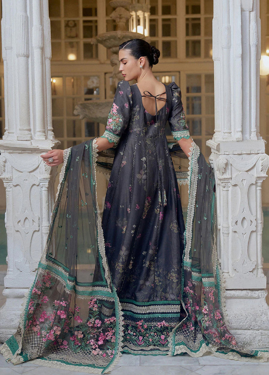 Back view of a woman wearing black floral embroidered lawn suit with half sleeves and lace detailing, showing the net dupatta draped elegantly with floral embroidery and lace edges.