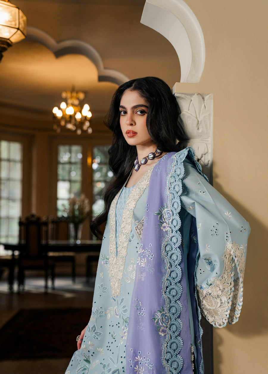 Close-up of woman wearing detailed floral embroidered ice blue kameez with lavender lace-trimmed dupatta indoors
