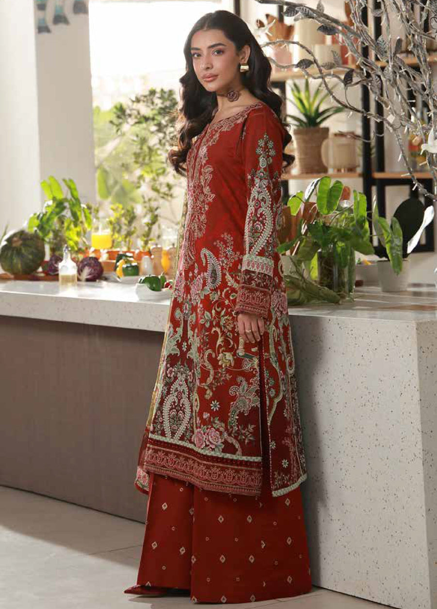 Side angle showing intricate embroidery on sleeves and floral patterns on the maroon lawn shirt paired with wide-leg trousers