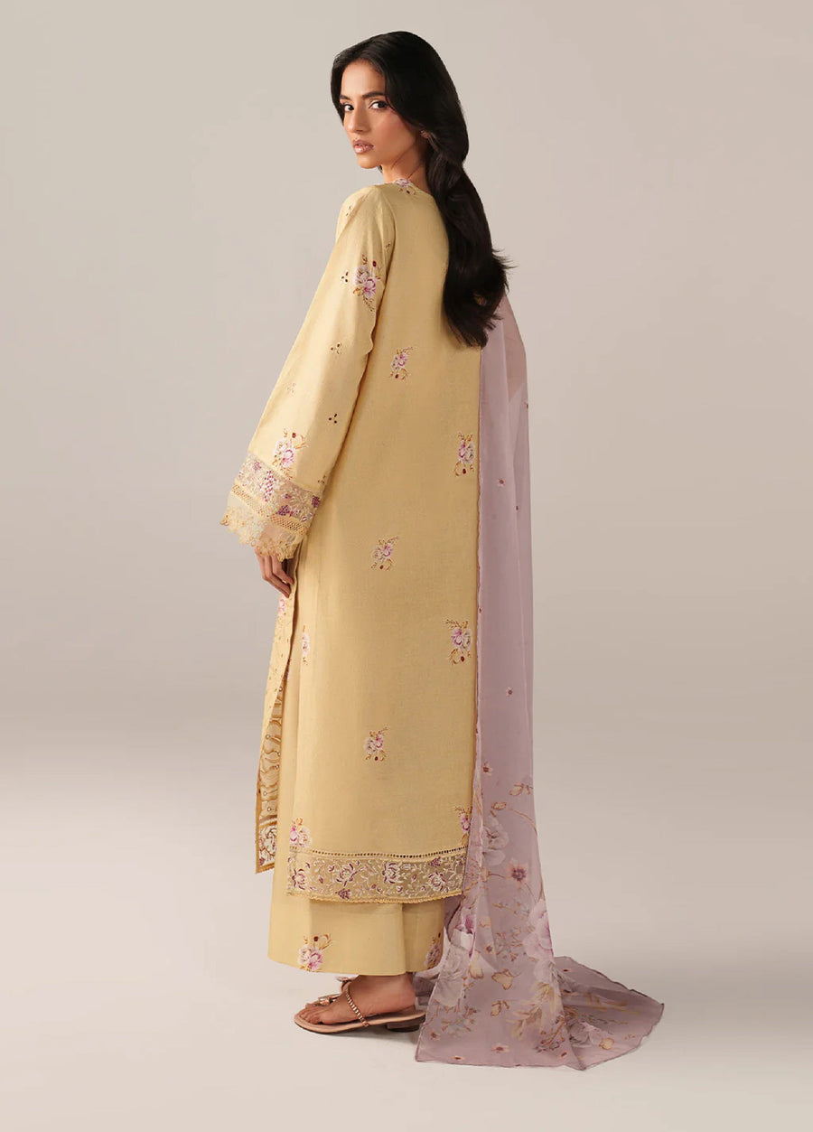Back view of embroidered lawn suit highlighting floral designs on fabric and full-length lilac floral dupatta trailing behind.