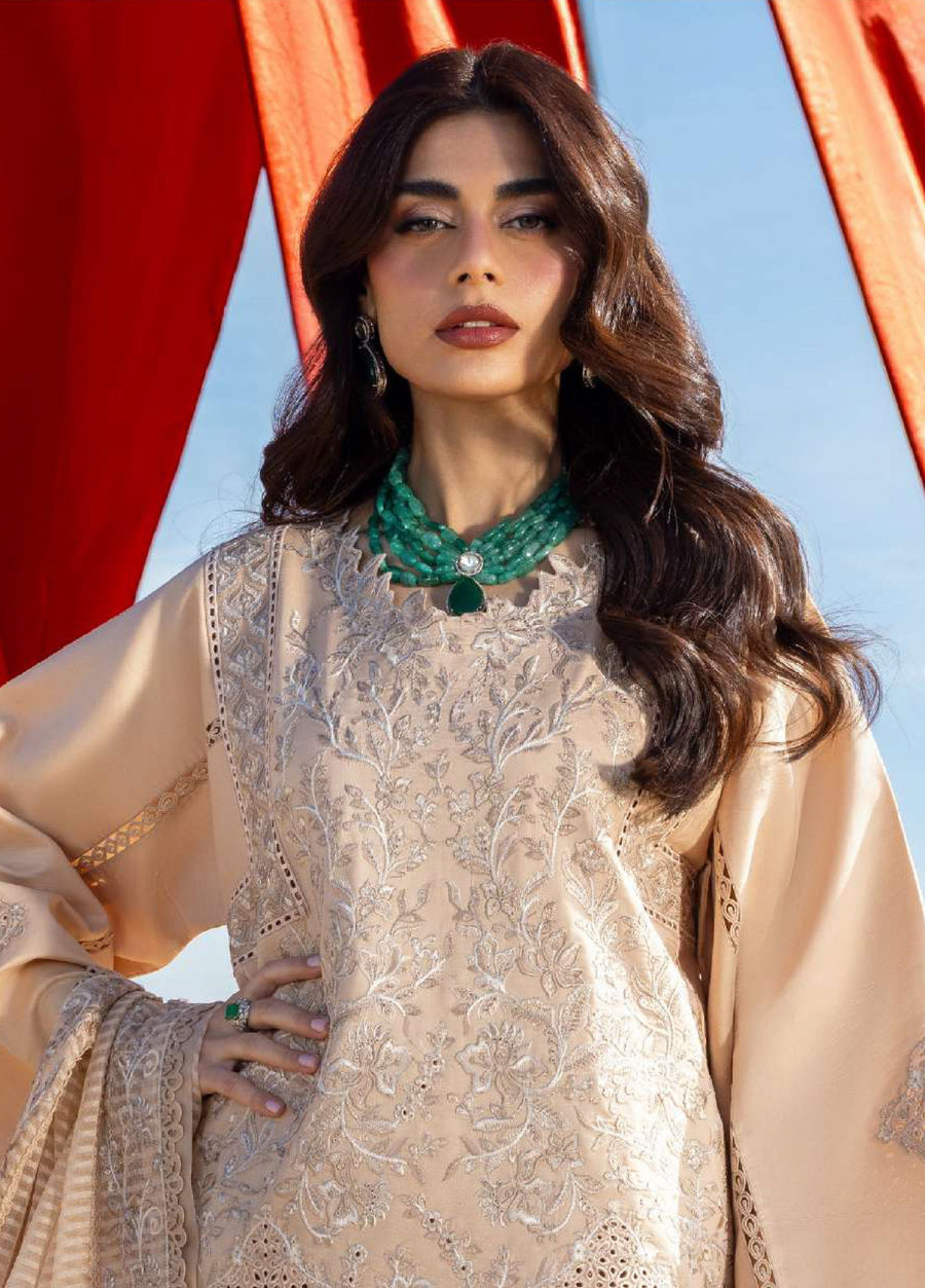 Close up of upper body showing detailed floral embroidery on front of beige lawn shirt and intricate cutwork on sleeves