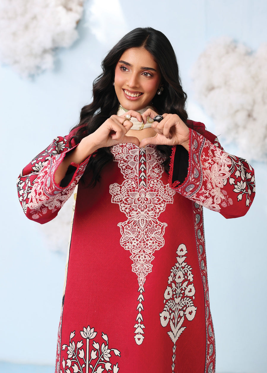 Close-up of woman smiling, highlighting intricate white embroidery on the neckline and sleeves of the red lawn shirt